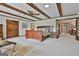 Spacious primary bedroom featuring carpet, beamed ceilings, and a sitting area at 115 Ebenezer Church Rd, Fayetteville, GA 30215