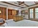 Spacious office featuring wooden ceiling beams, custom built-in bookshelves, and a large executive desk at 115 Ebenezer Church Rd, Fayetteville, GA 30215