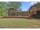 Expansive rear exterior view showcasing a large deck and numerous windows at 115 Ebenezer Church Rd, Fayetteville, GA 30215