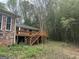 Exterior view of backyard featuring a wood deck with stairs next to bamboo grove at 130 Sandy Dr, Stockbridge, GA 30281