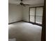 A bedroom featuring neutral carpet, a ceiling fan, and natural light from a window at 130 Sandy Dr, Stockbridge, GA 30281