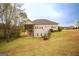 Backyard view showcasing a screened porch and well-maintained lawn, creating a serene outdoor space at 118 Jasmine Way, Villa Rica, GA 30180
