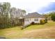 Backyard view showcases a screened porch and well-maintained lawn, creating a serene outdoor space at 118 Jasmine Way, Villa Rica, GA 30180