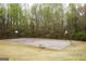 Community basketball court surrounded by trees offering a space for recreation and exercise at 118 Jasmine Way, Villa Rica, GA 30180