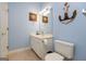 Charming bathroom featuring a vanity, toilet, tub-shower, and coastal decor at 118 Jasmine Way, Villa Rica, GA 30180
