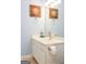 Bathroom vanity featuring compass themed artwork, lighting, and sink at 118 Jasmine Way, Villa Rica, GA 30180