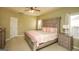Spacious bedroom featuring a decorative headboard, ceiling fan and natural light at 118 Jasmine Way, Villa Rica, GA 30180