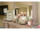 Close up of a decorative display including a clock, candles, and glass orbs on the dresser at 118 Jasmine Way, Villa Rica, GA 30180