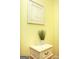 Elegant decor featuring a framed print, potted plant, and a vintage nightstand at 118 Jasmine Way, Villa Rica, GA 30180