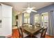 Stylish dining room with a modern ceiling fan, hardwood floors, and plenty of natural light at 118 Jasmine Way, Villa Rica, GA 30180