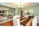 Open dining area with stylish table, chandelier, and decor, flowing into the adjacent living room space at 118 Jasmine Way, Villa Rica, GA 30180