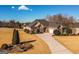 Beautiful brick home with a manicured front yard and a long driveway leading to a two-car garage at 118 Jasmine Way, Villa Rica, GA 30180