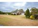 Light-colored home with attached garage, and lush lawn, set on a well-maintained lawn at 118 Jasmine Way, Villa Rica, GA 30180