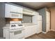 Bright kitchen features white appliances and light countertops at 118 Jasmine Way, Villa Rica, GA 30180