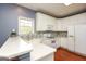 Modern kitchen features white cabinetry, hardwood floors, and stainless-steel appliances at 118 Jasmine Way, Villa Rica, GA 30180
