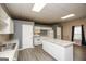 Modern kitchen features white cabinets, gray countertops, island and stainless appliances at 118 Jasmine Way, Villa Rica, GA 30180