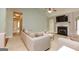 Comfortable living room with neutral tones, a fireplace, and a seamless connection to other areas of the home at 118 Jasmine Way, Villa Rica, GA 30180