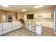 Open-concept living area with a modern kitchen, island with seating and a gray sofa at 118 Jasmine Way, Villa Rica, GA 30180