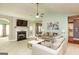 Bright living room featuring a fireplace, ceiling fan, and comfortable neutral-toned furniture at 118 Jasmine Way, Villa Rica, GA 30180