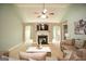 Spacious living room featuring a fireplace, ceiling fan, and comfortable neutral-toned furniture at 118 Jasmine Way, Villa Rica, GA 30180