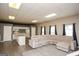 Bright living room with an open floorplan to the kitchen and gray sectional sofa at 118 Jasmine Way, Villa Rica, GA 30180