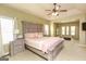 Spacious primary bedroom with trey ceiling, king bed, sitting area, and lots of natural light at 118 Jasmine Way, Villa Rica, GA 30180