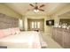 Bright main bedroom with a trey ceiling, expansive seating area with a leather ottoman at 118 Jasmine Way, Villa Rica, GA 30180