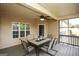 Comfortable covered patio featuring a dining set, ceiling fan, and serene outdoor views at 118 Jasmine Way, Villa Rica, GA 30180