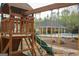 Playground with swings and a slide, set against the backdrop of the community pool area at 118 Jasmine Way, Villa Rica, GA 30180