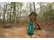 Charming wooden playground in a wooded area, offering a fun and safe space for children at 118 Jasmine Way, Villa Rica, GA 30180