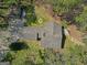 Aerial perspective of the home showcasing a large roof and secluded placement amidst mature trees and greenery at 150 Mary Lynn Ln, Fayetteville, GA 30214