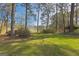 Picturesque backyard view with lush green lawn and serene lake in the distance, perfect for relaxation at 150 Mary Lynn Ln, Fayetteville, GA 30214