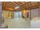 Spacious unfinished basement featuring a staircase, brick fireplace, and exposed ceiling beams at 150 Mary Lynn Ln, Fayetteville, GA 30214