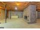 Unfinished basement with brick fireplace, concrete floors, and exposed ceiling, offering renovation potential at 150 Mary Lynn Ln, Fayetteville, GA 30214