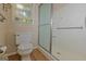 Bathroom featuring a toilet and walk-in shower with safety bar and window providing natural light at 150 Mary Lynn Ln, Fayetteville, GA 30214