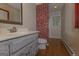 Bathroom featuring a brick accent wall, tile flooring, and white vanity at 150 Mary Lynn Ln, Fayetteville, GA 30214