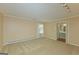 Spacious carpeted bedroom featuring a window, trimwork, and an ensuite bathroom at 150 Mary Lynn Ln, Fayetteville, GA 30214