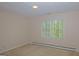 Bright bedroom featuring neutral walls, carpet, and a large window letting in natural light at 150 Mary Lynn Ln, Fayetteville, GA 30214