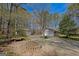 Spacious driveway featuring a fire pit and a detached garage, offering ample parking and outdoor living space at 150 Mary Lynn Ln, Fayetteville, GA 30214