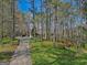 Long driveway leading to a charming house surrounded by lush trees and landscaping, offering a secluded retreat at 150 Mary Lynn Ln, Fayetteville, GA 30214