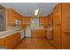 Well-lit kitchen featuring wooden cabinetry, hardwood floors, and modern appliances at 150 Mary Lynn Ln, Fayetteville, GA 30214