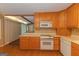 Kitchen with wooden cabinets, modern appliances and hardwood floors at 150 Mary Lynn Ln, Fayetteville, GA 30214