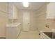 Functional laundry room with ample storage space and a utility sink at 150 Mary Lynn Ln, Fayetteville, GA 30214