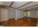 Spacious living room with hardwood floors, wooden ceiling beams, and a ceiling fan at 150 Mary Lynn Ln, Fayetteville, GA 30214