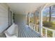 Charming covered porch featuring a comfortable bench and scenic views, perfect for relaxing and enjoying the outdoors at 150 Mary Lynn Ln, Fayetteville, GA 30214