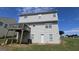Rear exterior of home with a wooden deck and back door surrounded by well-maintained lawn at 771 Franklin Mill Trce, Loganville, GA 30052