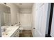 This bathroom offers a single vanity, a tub shower with sliding door and tile flooring at 771 Franklin Mill Trce, Loganville, GA 30052