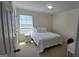 This bedroom offers neutral walls and carpeting, plus a full bed with ample natural light at 771 Franklin Mill Trce, Loganville, GA 30052
