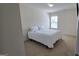 Carpeted bedroom with bright natural light from the window. The full bed is set with fresh white linens at 771 Franklin Mill Trce, Loganville, GA 30052