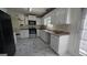 Bright kitchen featuring white cabinets, black appliances, and modern countertops at 771 Franklin Mill Trce, Loganville, GA 30052